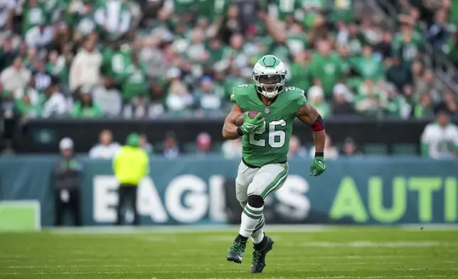 Philadelphia Eagles running back Saquon Barkley (26) runs the ball against the Dallas Cowboys during the second half of an NFL football game, Sunday, Dec. 29, 2024, in Philadelphia. (AP Photo/Matt Slocum)