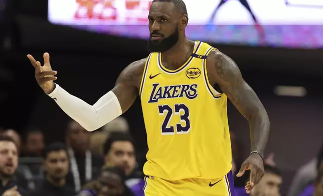 Los Angeles Lakers forward LeBron James (23) celebrates after scoring against the Sacramento Kings during the second half of an NBA basketball game in Sacramento, Calif., Thursday, Dec. 19, 2024. (AP Photo/Jed Jacobsohn)