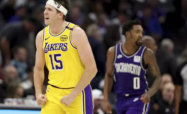 Los Angeles Lakers guard Austin Reaves (15) celebrates after scoring against the Sacramento Kings during the second half of an NBA basketball game in Sacramento, Calif., Thursday, Dec. 19, 2024. (AP Photo/Jed Jacobsohn)