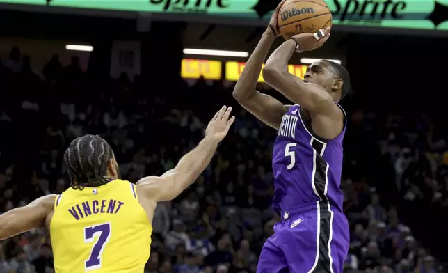 Sacramento Kings guard De'Aaron Fox (5) shoots against Los Angeles Lakers guard Gabe Vincent (7) during the second half of an NBA basketball game in Sacramento, Calif., Thursday, Dec. 19, 2024. (AP Photo/Jed Jacobsohn)