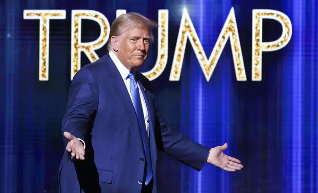President-elect Donald Trump takes the stage before he speaks at the FOX Nation Patriot Awards, Thursday, Dec. 5, 2024, in Greenvale, N.Y. (AP Photo/Heather Khalifa)