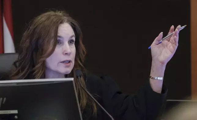 Fulton County Superior Court Judge Paige Reese Whitaker speaks with a prosecutor during the Young Thug trial at Fulton County Courthouse in Atlanta on Tuesday, Nov. 26, 2024. (Miguel Martinez/Atlanta Journal-Constitution via AP)