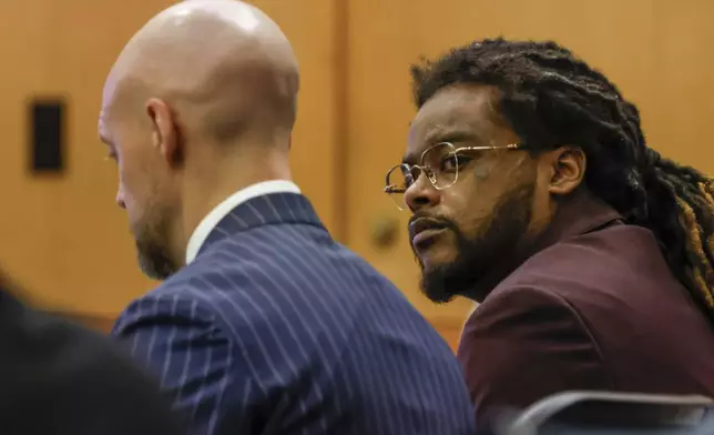 Shannon Stillwell, right, sits with his attorney, Max Schardt left, as he looks at the prosecutors during the Young Thug trial at Fulton County Courthouse in Atlanta on Tuesday, Nov. 26, 2024. (Miguel Martinez/Atlanta Journal-Constitution via AP)