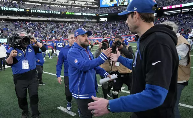 New York Giants head coach Brian Daboll, center, meets Indianapolis Colts head coach Shane Steichen, right, on the field after the Giants' 45-33 win in an NFL football game Sunday, Dec. 29, 2024, in East Rutherford, N.J. (AP Photo/Seth Wenig)