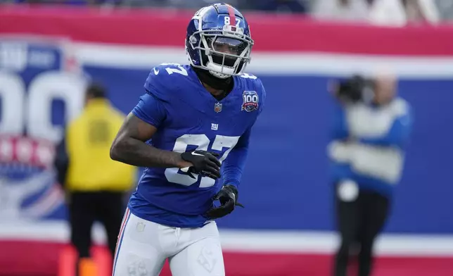 New York Giants' Ihmir Smith-Marsette (87) runs to the bench after returning a kickoff for a touchdown against the Indianapolis Colts in the second half of an NFL football game Sunday, Dec. 29, 2024, in East Rutherford, N.J. (AP Photo/Seth Wenig)