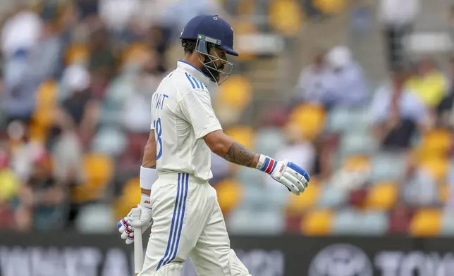 India's Virat Kohli walks off the field after losing his wicket during play on day three of the third cricket test between India and Australia at the Gabba in Brisbane, Australia, Monday, Dec. 16, 2024. (AP Photo/Pat Hoelscher)