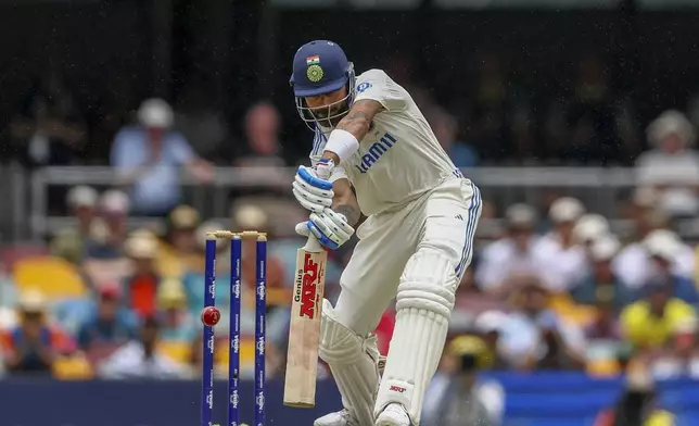 India's Virat Kohli bats during play on day three of the third cricket test between India and Australia at the Gabba in Brisbane, Australia, Monday, Dec. 16, 2024. (AP Photo/Pat Hoelscher)