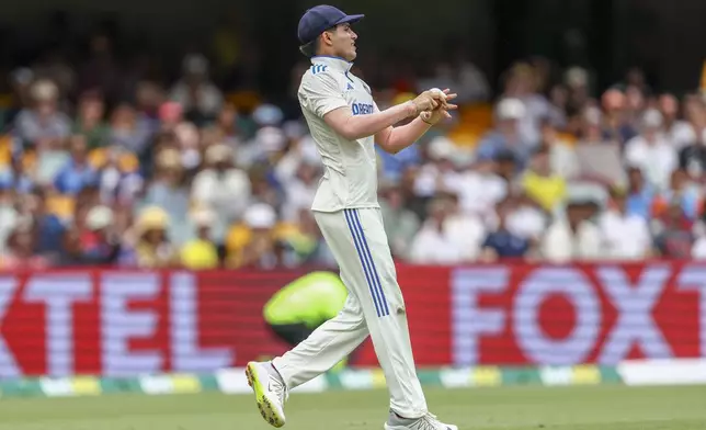 India's Shubman Gill takes the catch to dismiss Australia's Alex Carey during play on day three of the third cricket test between India and Australia at the Gabba in Brisbane, Australia, Monday, Dec. 16, 2024. (AP Photo/Pat Hoelscher)