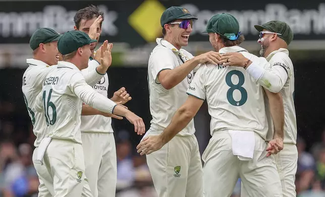 Australian players celebrates the wicket of India's Shubman Gill during play on day three of the third cricket test between India and Australia at the Gabba in Brisbane, Australia, Monday, Dec. 16, 2024. (AP Photo/Pat Hoelscher)