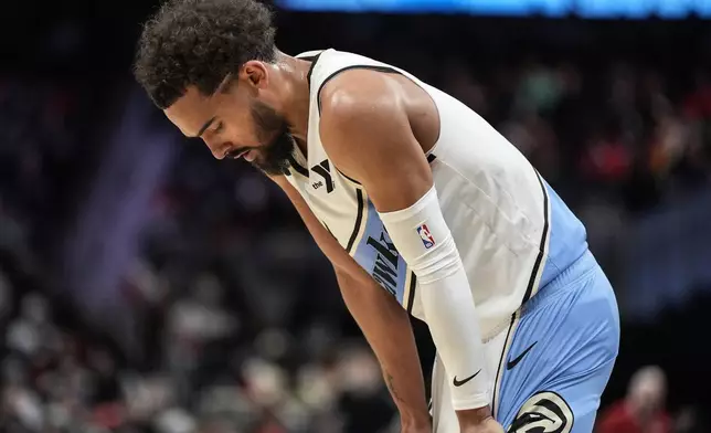 Atlanta Hawks guard Trae Young (11) stands on the court against the Minnesota Timberwolves during the first half of an NBA basketball game, Monday, Dec. 23, 2024, in Atlanta. (AP Photo/Mike Stewart)