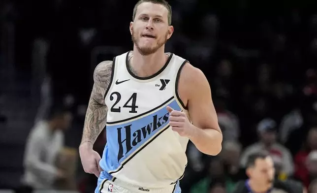 Atlanta Hawks guard Garrison Mathews (24) runs after hitting a thre-point shot against the Minnesota Timberwolves during the first half of an NBA basketball game, Monday, Dec. 23, 2024, in Atlanta. (AP Photo/Mike Stewart)