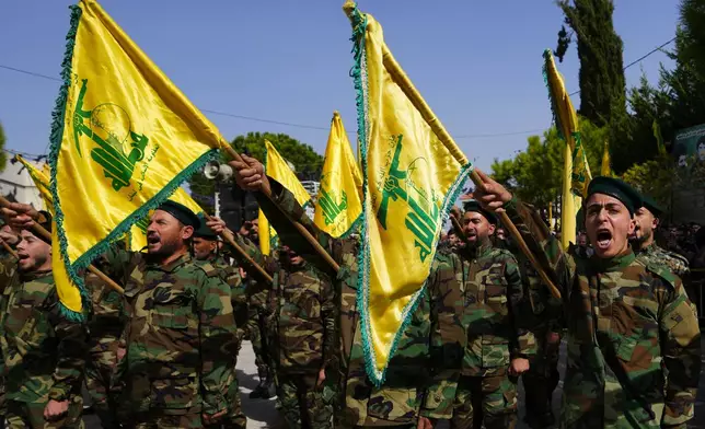 FILE - Hezbollah fighters attend the funeral procession of a Hezbollah militant who was killed by Israeli shelling, in south Lebanon, Oct. 22, 2023. (AP Photo/Hassan Ammar, File)