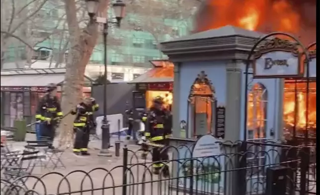 In this image taken from video provided by Eugene McGuire , FDNY respond to a fire at an outdoor holiday market in Bryant Park on Friday, Dec. 27, 2024 in New York. (Eugene McGuire via AP)