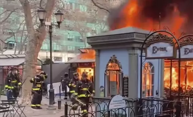 In this image taken from video provided by Eugene McGuire , FDNY respond to a fire at an outdoor holiday market in Bryant Park on Friday, Dec. 27, 2024 in New York. (Eugene McGuire via AP)