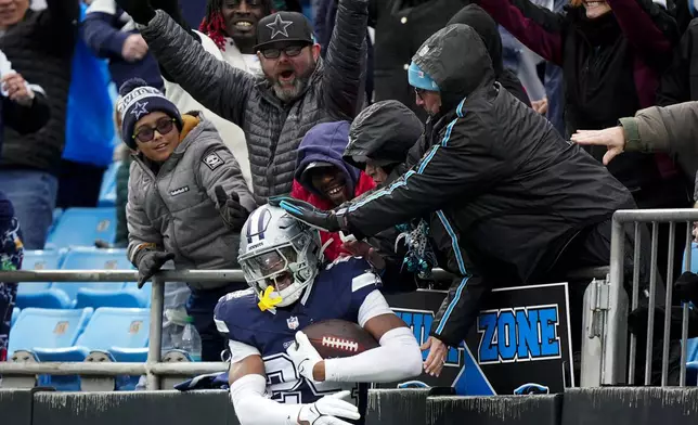 Dallas Cowboys safety Israel Mukuamu celebrates after an interception against the Carolina Panthers during the second half of an NFL football game, Sunday, Dec. 15, 2024, in Charlotte, N.C. (AP Photo/Jacob Kupferman)