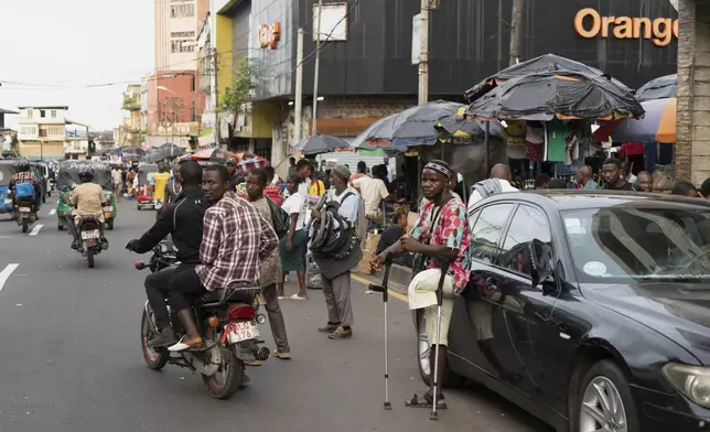 An amputee begs in the streets of Freetown, Sierra Leone, Wednesday, Sept. 25, 2024. (AP Photo/Jack Thompson)