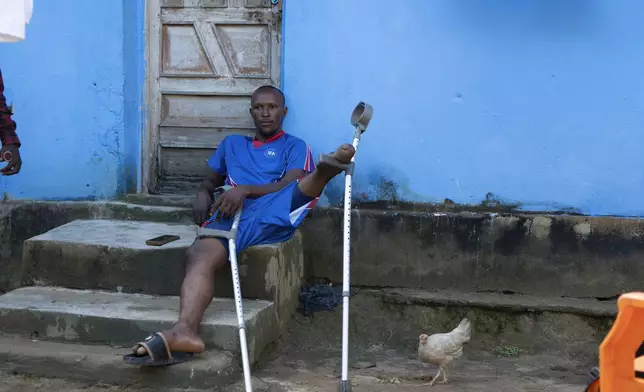 Alimany Kani sits outside his home in Waterloo, Sierra Leone, Wednesday, Sept. 25, 2024. (AP Photo/Jack Thompson)