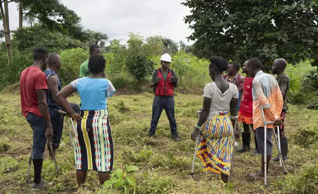 Mambud Samai, the founder of Farming on Crutches and a pastor, leads a session on sustainable farming in Freetown, Sierra Leone, Wednesday, Sept. 25, 2024. (AP Photo/Jack Thompson)