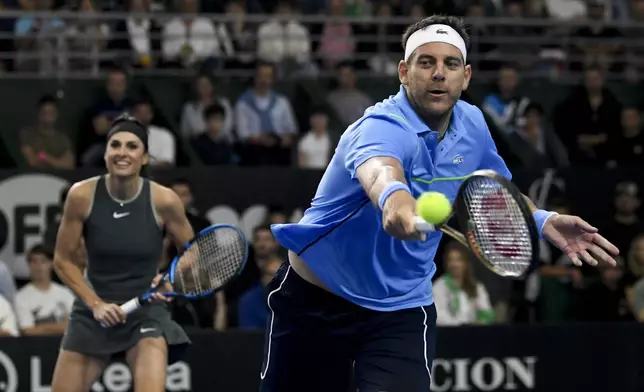 Former tennis players Juan Martin Del Potro returns the ball alongside Gabriela Sabatini during an exhibition doubles tennis match against Serbia's Novak Djokovic and Gisela Dulko in Buenos Aires, Argentina, Sunday, Dec. 1, 2024. (AP Photo/Gustavo Garello)