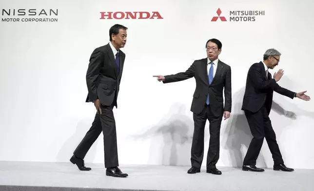 Nissan Chief Executive Makoto Uchida, left, Takao Kato, CEO of Mitsubishi Motors, center, and Honda Chief Executive Toshihiro Mibe, right, leave after a joint news conference in Tokyo, Japan, Monday, Dec. 23, 2024. (AP Photo/Eugene Hoshiko)