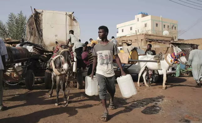 FILE - People gather to collect water in Khartoum, Sudan, May 28, 2023. (AP Photo/Marwan Ali, File)