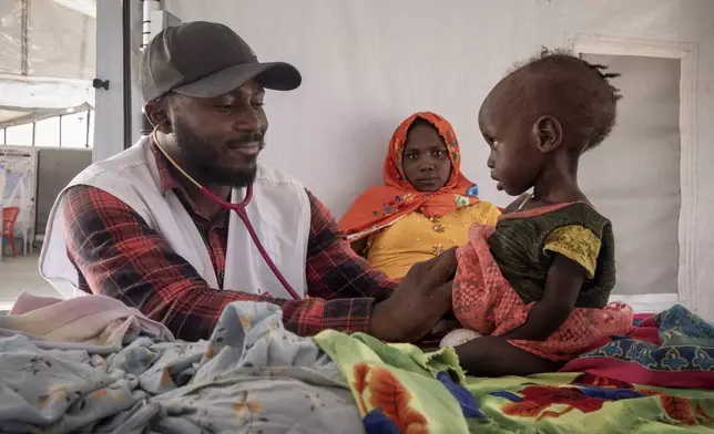 FILE - A doctor treats a Sudanese child suffering from malnutrition are treated at an MSF clinic in Metche Camp, Chad, near the Sudanese border, on April 6, 2024. (AP Photo/Patricia Simon, File)