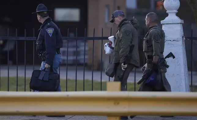 Indiana State Police officers enter Indiana State Prison on Tuesday, Dec. 17, 2024, in Michigan City, Ind., where, barring last-minute court action or intervention by Gov. Eric Holcomb, Joseph Corcoran, 49, convicted in the 1997 killings of his brother and three other people, is scheduled to be put to death by lethal injection before sunrise Wednesday, Dec. 18. (AP Photo/Erin Hooley)