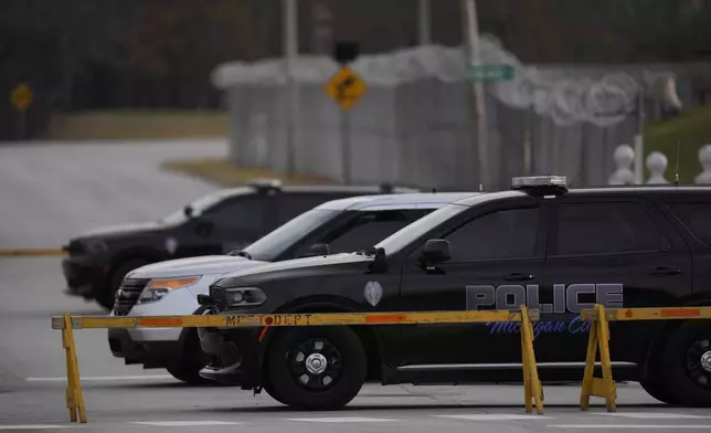 Police cars are parked outside of Indiana State Prison on Tuesday, Dec. 17, 2024, in Michigan City, Ind., where, barring last-minute court action or intervention by Gov. Eric Holcomb, Joseph Corcoran, 49, convicted in the 1997 killings of his brother and three other people, is scheduled to be put to death by lethal injection before sunrise Wednesday, Dec. 18. (AP Photo/Erin Hooley)