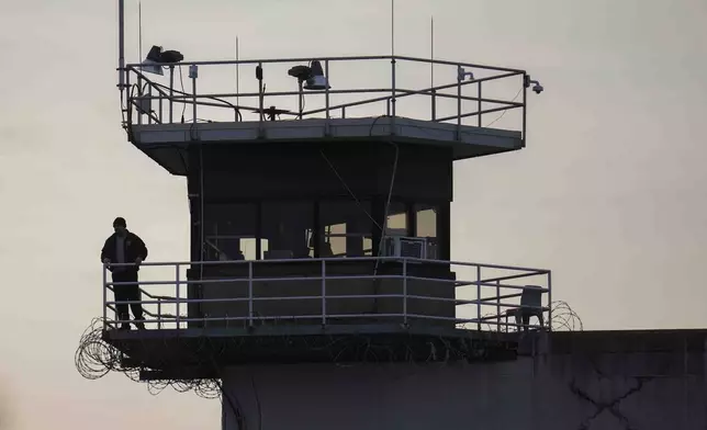 A guard stands in a tower at Indiana State Prison on Tuesday, Dec. 17, 2024, in Michigan City, Ind., where, barring last-minute court action or intervention by Gov. Eric Holcomb, Joseph Corcoran, 49, convicted in the 1997 killings of his brother and three other people, is scheduled to be put to death by lethal injection before sunrise Wednesday, Dec. 18. (AP Photo/Erin Hooley)