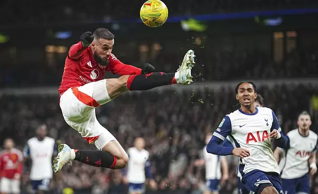 Manchester United's Noussair Mazraoui in action during the English League Cup quarter-final soccer match between Tottenham and Manchester United, at the Tottenham Hotspur Stadium in London, Thursday, Dec. 19, 2024. (AP Photo/Dave Shopland )