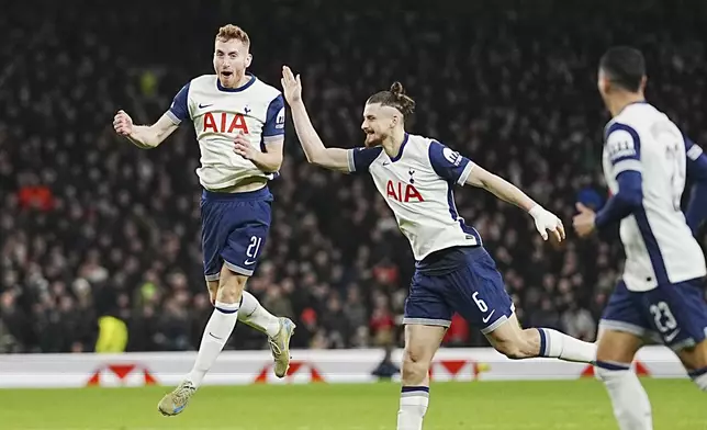 Tottenham's Dejan Kulusevski, left, celebrates after scoring his side's second goal during the English League Cup quarter-final soccer match between Tottenham and Manchester United, at the Tottenham Hotspur Stadium in London, Thursday, Dec. 19, 2024. (AP Photo/Dave Shopland )