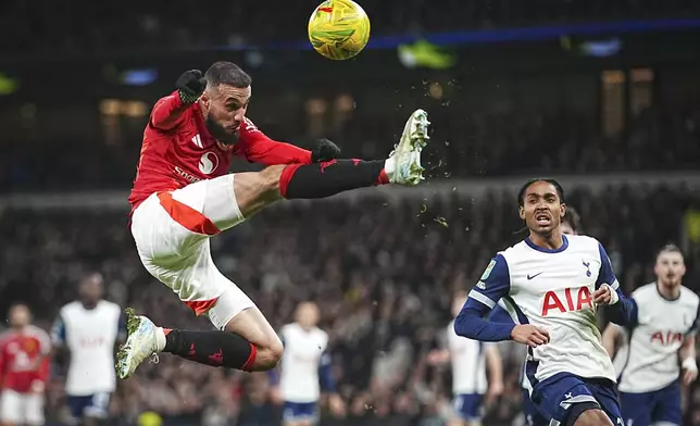 Manchester United's Noussair Mazraoui in action during the English League Cup quarter-final soccer match between Tottenham and Manchester United, at the Tottenham Hotspur Stadium in London, Thursday, Dec. 19, 2024. (AP Photo/Dave Shopland )