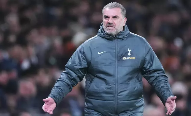 Tottenham's head coach Ange Postecoglou reacts during the English League Cup quarter-final soccer match between Tottenham and Manchester United, at the Tottenham Hotspur Stadium in London, Thursday, Dec. 19, 2024. (AP Photo/Dave Shopland )