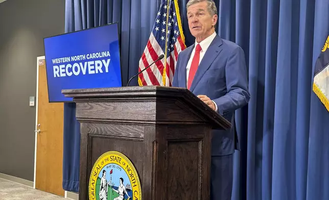 FILE - North Carolina Gov. Roy Cooper unveils a report during a press conference in Raleigh, N.C., Oct. 23, 2024. (AP Photo/Gary D. Robertson, File)