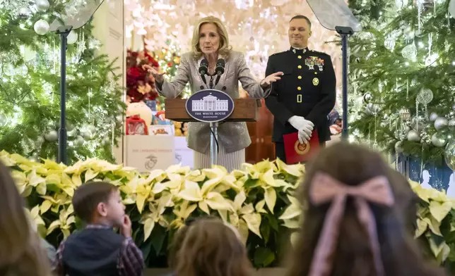 First lady Jill Biden speaks as she hosts a Toys for Tots event with Marine Corps families in the East Room at the White House in Washington, Friday, Dec. 13, 2024. At right is Lt. Gen. Leonard Anderson, Commander of the U.S. Marine Corps Reserve. (AP Photo/Mark Schiefelbein)