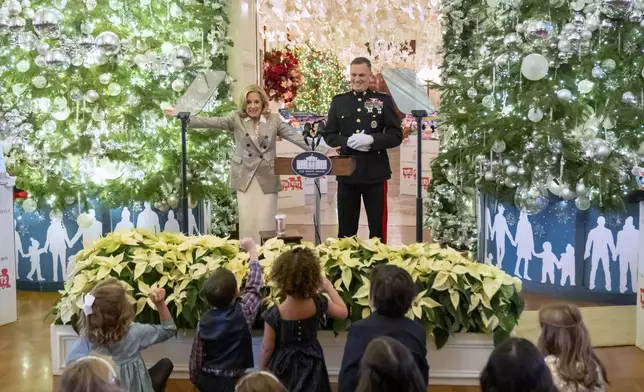 First lady Jill Biden speaks as she hosts a Toys for Tots event with Marine Corps families in the East Room at the White House in Washington, Friday, Dec. 13, 2024. At right is Lt. Gen. Leonard Anderson, Commander of the U.S. Marine Corps Reserve. (AP Photo/Mark Schiefelbein)