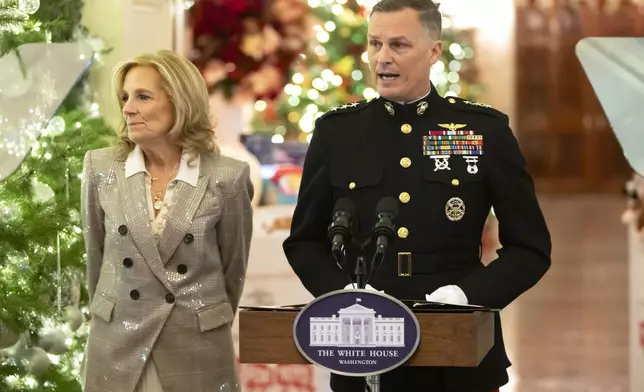 Lt. Gen. Leonard Anderson, Commander of the U.S. Marine Corps Reserve, speaks as first lady Jill Biden listens during a Toys for Tots event with Marine Corps families in the East Room at the White House in Washington, Friday, Dec. 13, 2024. (AP Photo/Mark Schiefelbein)