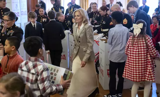 First lady Jill Biden sorts toys as she hosts a Toys for Tots event with Marine Corps families in the East Room at the White House in Washington, Friday, Dec. 13, 2024. (AP Photo/Mark Schiefelbein)