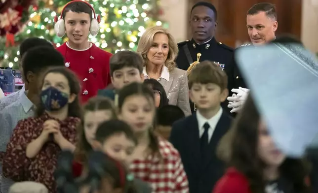 First lady Jill Biden arrives with children of Marine Corps families as she hosts a Toys for Tots event in the East Room at the White House in Washington, Friday, Dec. 13, 2024. (AP Photo/Mark Schiefelbein)