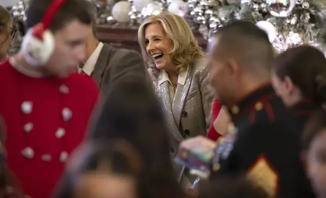 First lady Jill Biden laughs during a Toys for Tots event with Marine Corps families in the East Room at the White House in Washington, Friday, Dec. 13, 2024. (AP Photo/Mark Schiefelbein)