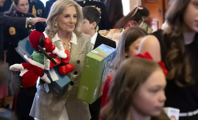 First lady Jill Biden sorts toys as she hosts a Toys for Tots event with Marine Corps families in the East Room at the White House in Washington, Friday, Dec. 13, 2024. (AP Photo/Mark Schiefelbein)