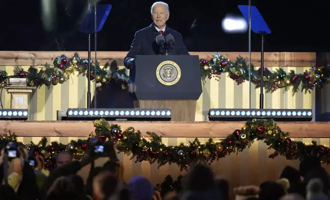 President Joe Biden speaks during a ceremony to light the National Christmas Tree on the Ellipse near the White House in Washington, Thursday, Dec. 5, 2024. (AP Photo/Mark Schiefelbein)