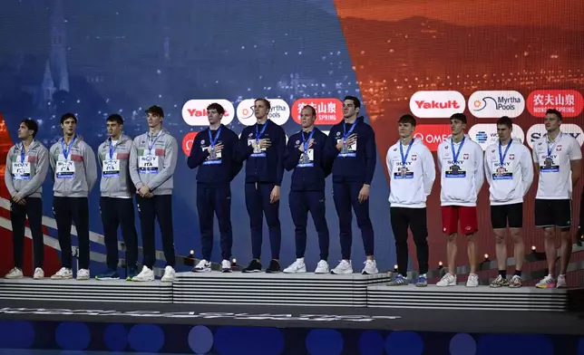 From left, second-placed Italy, first-placed United States, and third-placed Poland teams stand on the podium after the 4x100 meter freestyle final during the World Short Course Swimming Championships in Budapest, Hungary, Tuesday, Dec. 10, 2024. (AP Photo/Denes Erdos)