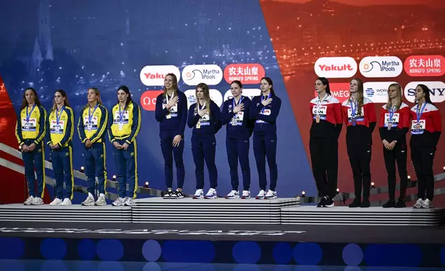 From the left second-placed Australia, first-placed United States, and third-placed Canada teams stand on the podium after 4x100 meter freestyle final during the World Short Course Swimming Championships in Budapest, Hungary, Tuesday, Dec. 10, 2024. (AP Photo/Denes Erdos)