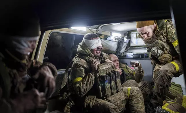 Injured Ukrainian servicemen arrive from the battlefield at Medical Service "Ulf" of the 108th Separate Battalion "Da Vinci Wolves" on Pokrovsk direction, Ukraine, Monday, Dec. 23, 2024. (AP Photo/Evgeniy Maloletka)