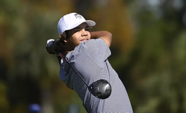 Charlie Woods tees off on the fifth hole during the first round of the PNC Championship golf tournament, Saturday, Dec. 21, 2024 in Orlando. (AP Photo/Phelan M. Ebenhack)