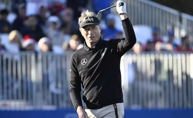 Bernhard Langer reacts after chipping onto the 18th green during the first round of the PNC Championship golf tournament, Saturday, Dec. 21, 2024, in Orlando, Fla. (AP Photo/Phelan M. Ebenhack)