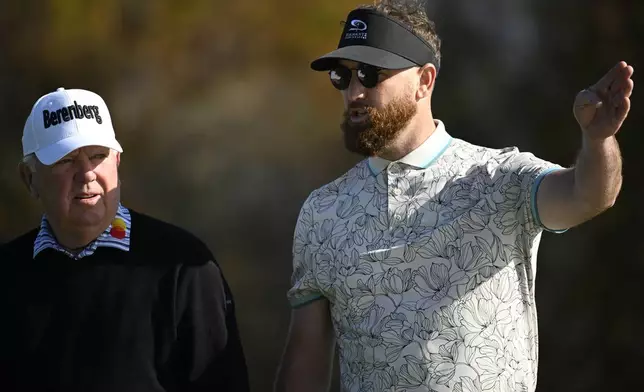 Mark O'Meara, left, and his son Shaun O'Meara talk about their next shot before teeing off on the fifth hole during the first round of the PNC Championship golf tournament, Saturday, Dec. 21, 2024 in Orlando. (AP Photo/Phelan M. Ebenhack)