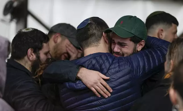 People attend the funeral of 1st Sgt. Yuval Shoham, who was killed in a battle in the Gaza Strip, during his burial at Mount Herzl military cemetery in Jerusalem, Monday, Dec. 30, 2024. (AP Photo/Matias Delacroix)