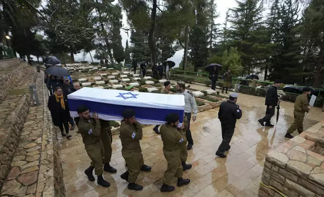 Israeli soldiers carry the flag-draped casket of 1st Sgt. Yuval Shoham, who was killed in a battle in the Gaza Strip, during his burial at the Mount Herzl military cemetery in Jerusalem, Monday, Dec. 30, 2024. (AP Photo/Matias Delacroix)